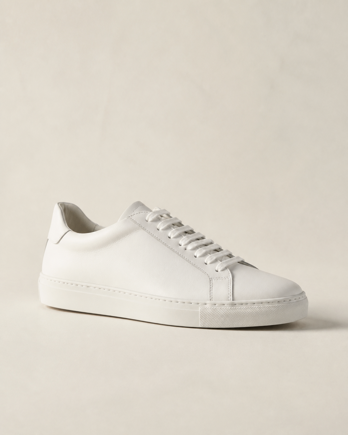 Draft product image of a white minimalist leather sneaker